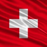 Switzerland flag design. Waving Swiss flag made of satin or silk fabric. Vector Illustration.